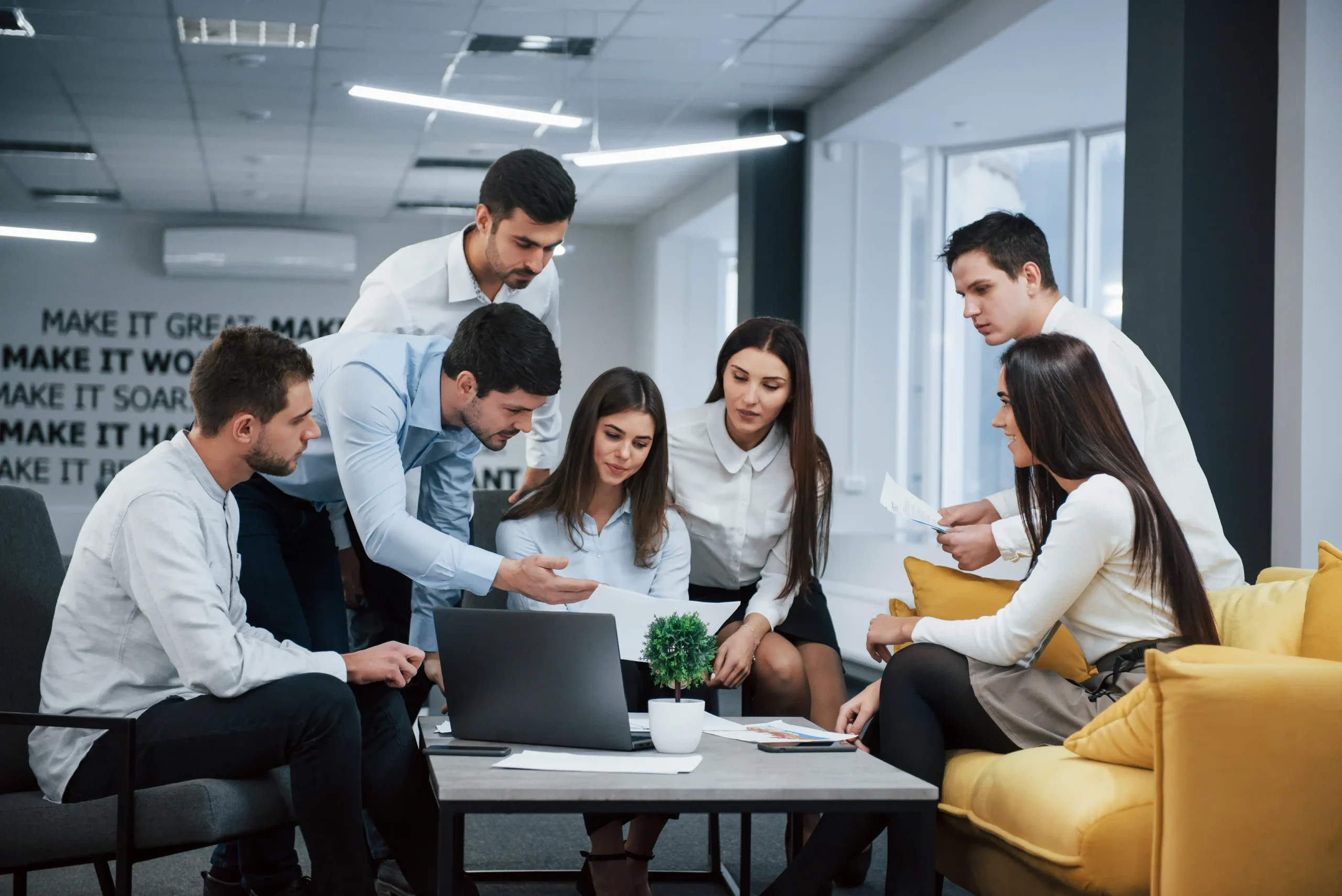 Team members reviewing campaign performance on a laptop